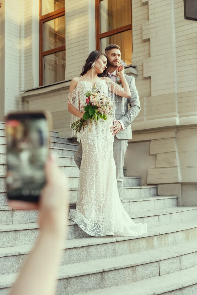 guest-making-photo-caucasian-romantic-young-couple-celebrating-marriage-city