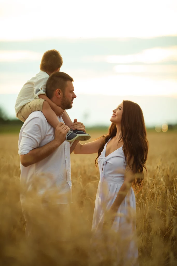 picture-cheerful-caucasian-mum-dad-their-child-have-fun-together-smiles-field