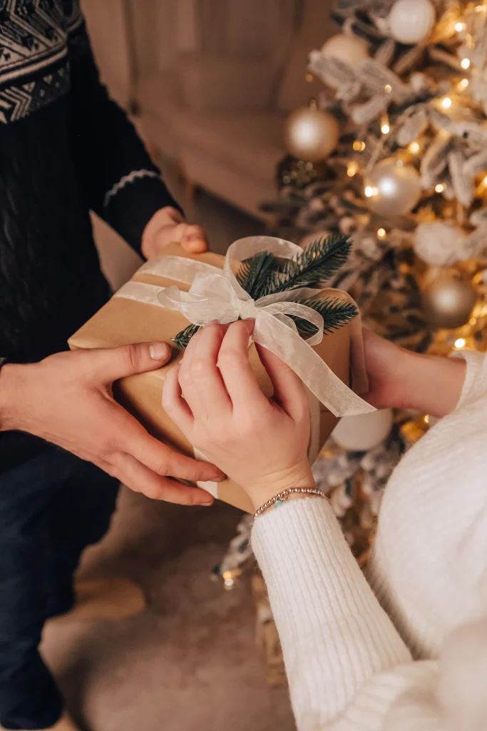 vertical-image-lovely-young-romantic-couple-sitting-open-gifts-presents-garlands-home-cosy-interior
