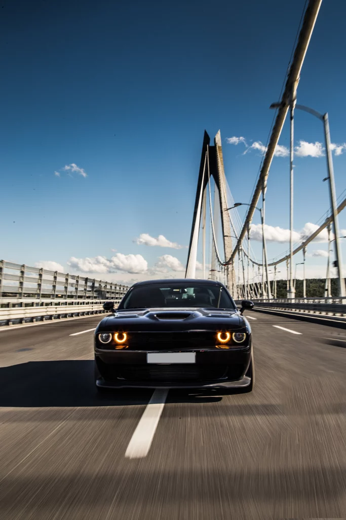 front-view-black-sedan-sport-car-bridge