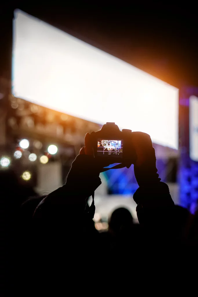 professional-dslr-camera-music-concert-raised-up-hand-recording-singer-stage