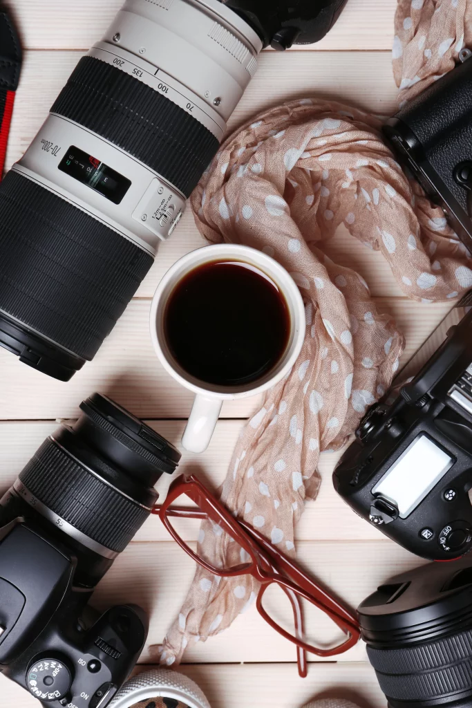 still-life-with-modern-cameras-wooden-table-top-view