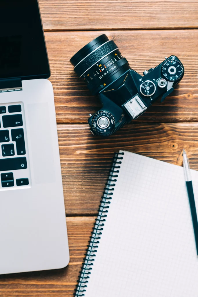 work-space-photographer-have-laptop-film-camera-note-wooden-table